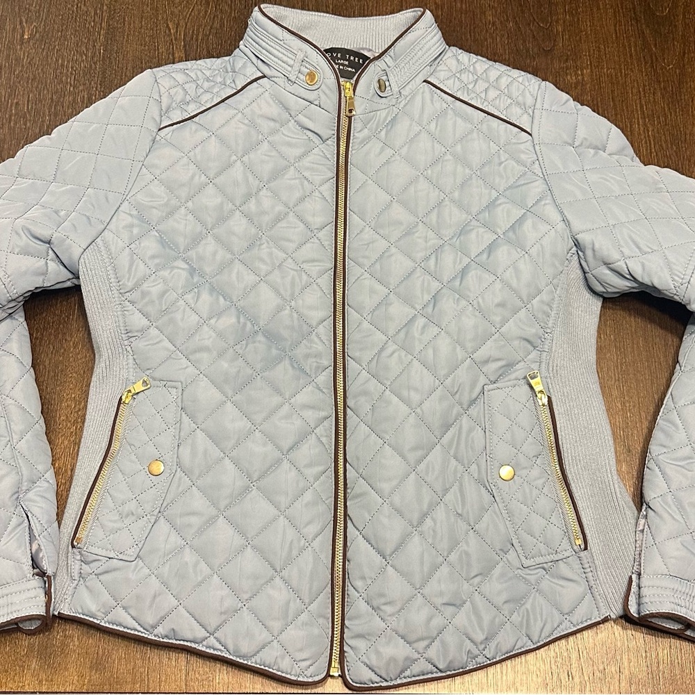 A light jacket by the brand Love Tree. Size large and is a dusty blue color.